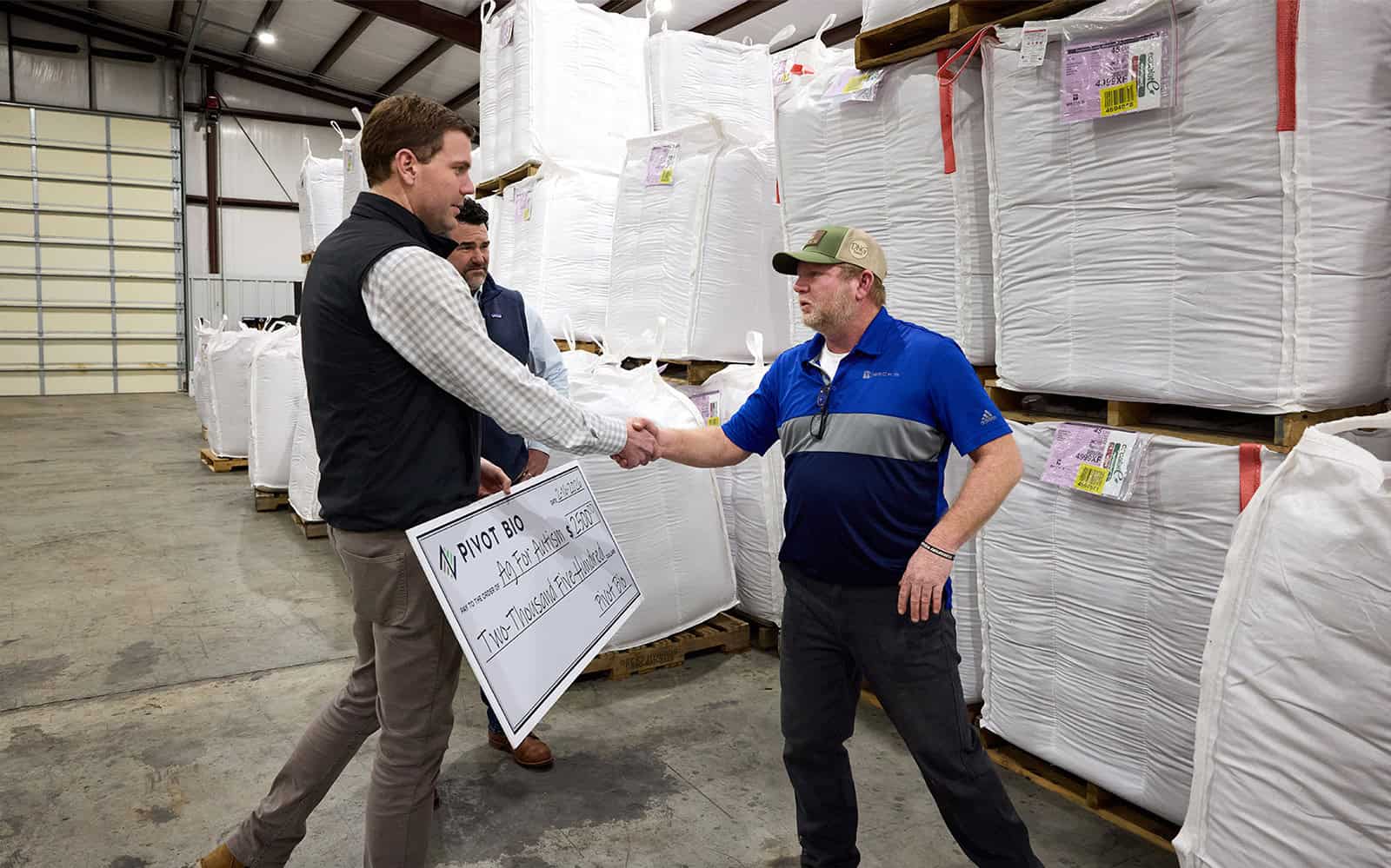 Chris Abbot handing Danny Graham a check for Ag For Autism