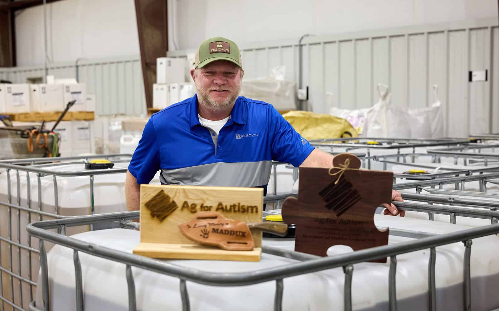 danny with ag for autism signage in warehouse