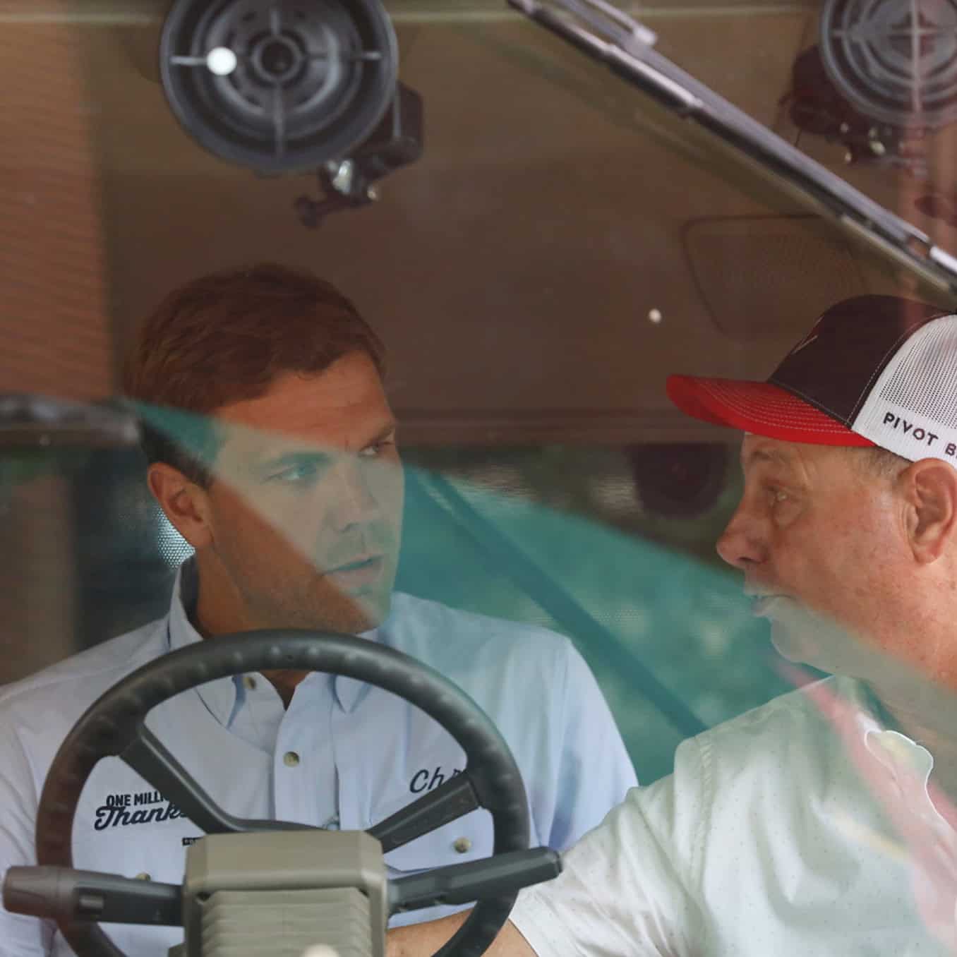 Chris, in the tractor with a guest in the buddy seat